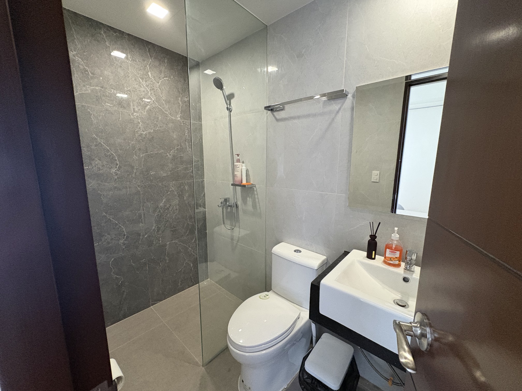 Stone-clad ensuite bathroom off the primary bedroom of the DAYON TA condo